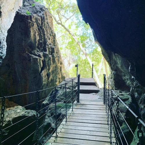 a stairway leading into a cave with a rock at Villa Mar Colina in Yeppoon