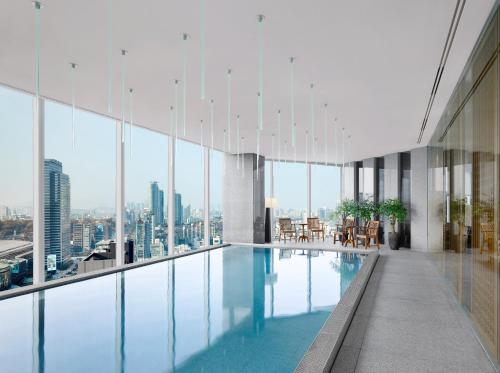 a pool in a building with a view of the city at Park Hyatt Seoul in Seoul