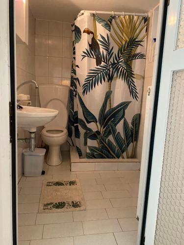 a bathroom with a toilet and a shower curtain at Studio Cleopatra in Kanali