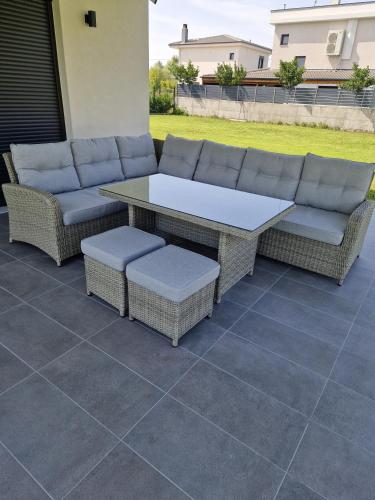 a patio with a table and two chairs and a table at VILLA SEA LUX PLAKA Litochorou in Plaka Litochorou