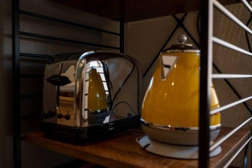 a toaster sitting on top of a wooden shelf at 日向サーフキャンプ111 in Hyuga