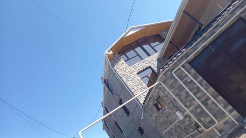 a building with a ladder on the side of it at Lahij Rashad Ismayilov Hotel in Lahıc