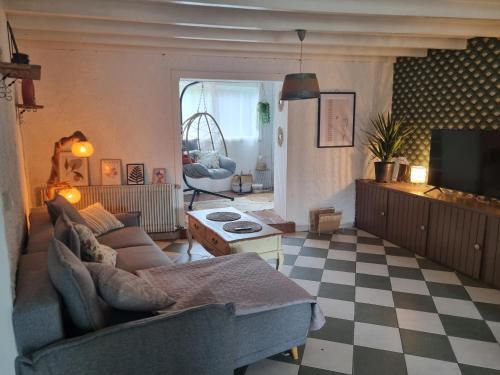 ein Wohnzimmer mit einem Sofa und einem Herd in der Unterkunft Le beauplan in Chalain-le-Comtal