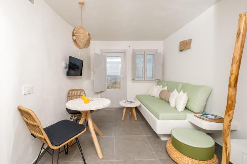 a living room with a couch and a table at CABO ESTE SUITES in Akrotiri