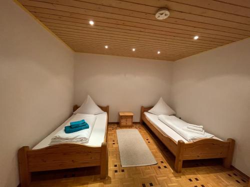 a room with two beds and a wooden floor at Ferienhaus Sofia in Urschmitt