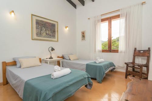a room with two beds and a window at Casa Miranda in Valldemossa