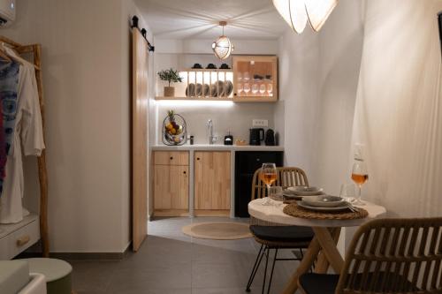 a small kitchen with a table and a dining room at CABO ESTE SUITES in Akrotiri