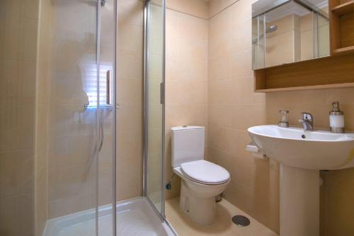 a bathroom with a shower and a toilet and a sink at Calpe Bay Apartment in Calpe