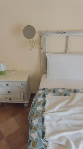 a bedroom with a bed and a side table at B&B La Buonora in Sinio