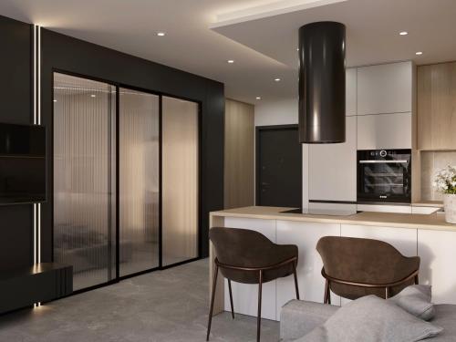 a kitchen with two chairs and a counter in a room at VIP APARTAMENT Lubelska in Rzeszów