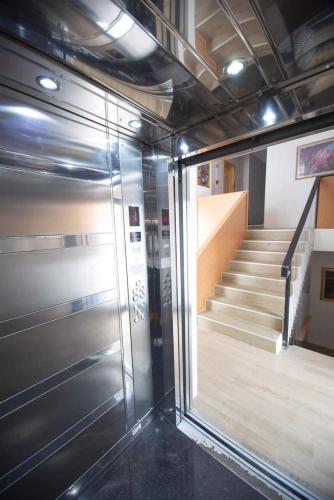 a room with a staircase and a glass elevator at Didveli Gallery B-211 in Bakuriani