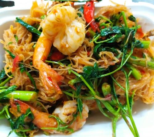 a white plate of food with shrimp and vegetables at Grand Residence Ngamwongwan 19 in Nonthaburi