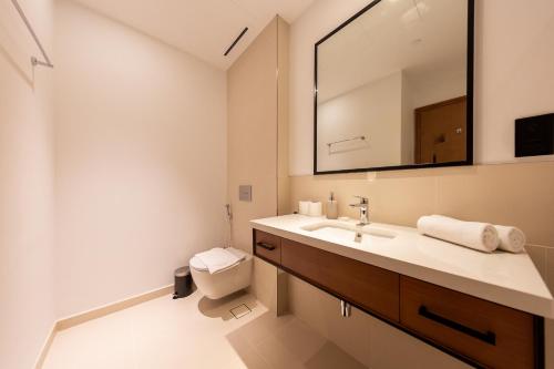 ein Bad mit einem Waschbecken und einem Spiegel in der Unterkunft BRAND-NEW 1 Bedroom with full Marina View in Dubai