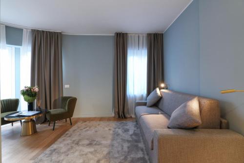 a living room with a couch and a table at PRESTIGE BOUTIQUE APARTHOTEL - Piazza Duomo View in Milan