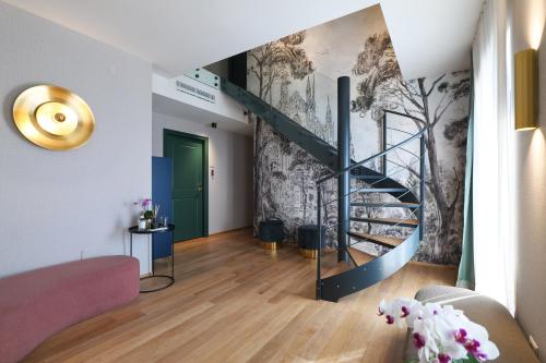 a living room with a staircase and a wall mural at PRESTIGE BOUTIQUE APARTHOTEL - Piazza Duomo View in Milan