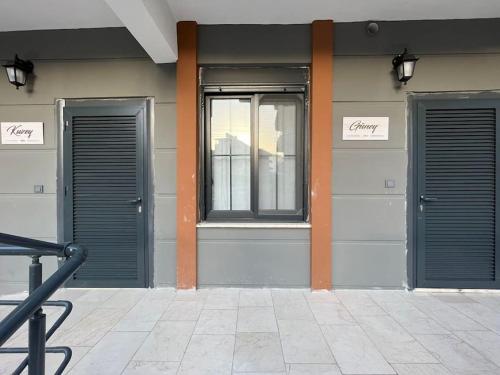 two doors on the side of a building at Kumsal Evleri & Kuzey - Bahçeli, Denize 200m in Bozyazı