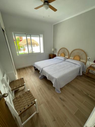 1 dormitorio con 1 cama grande y ventilador en Chalet SAO PAULO cerca de la playa en San Pedro del Pinatar