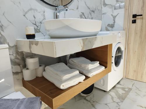 a bathroom with a sink and a washing machine at AEGEAN SUITES in Keramotí