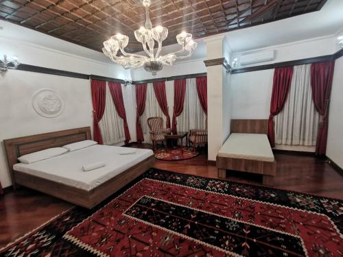 a bedroom with a bed and a chandelier at Villa Sv Sofija Old Town in Ohrid