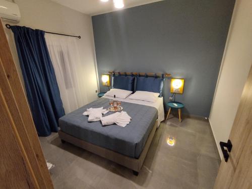 a bedroom with a bed with towels on it at AEGEAN SUITES in Keramoti