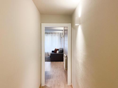 a hallway leading to a living room with a couch at ¡Más céntrico imposible! 6PAX+PK in Andorra la Vella