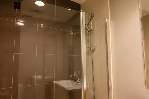 a bathroom with a shower and a sink at Mira Holiday Homes - Spacious Studio with Balcony - Free Wifi in Dubai
