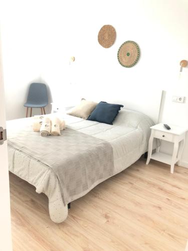 a bedroom with a bed with two stuffed animals on it at Vivienda de uso turístico Rio Lor 1 in Lugo