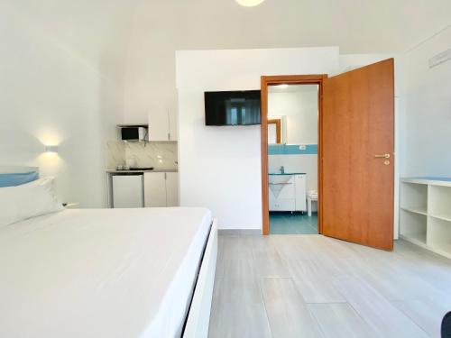 a bedroom with a bed and a wooden door at Joshua Home in Maiori
