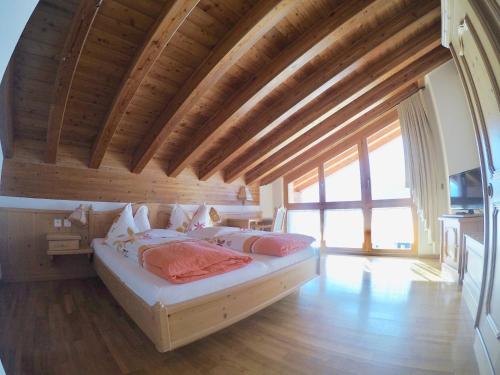 a bedroom with a bed in a room with wooden ceilings at Haus Adora in Leukerbad