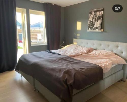 a large bed in a bedroom with a window at New luxurious Villa in Helsingborg close to the City in Helsingborg