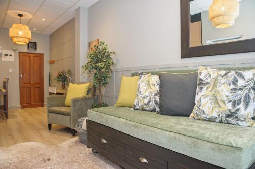 a living room with a couch and a chair at Royal Pearl, Insta-worthy APT in Paarl