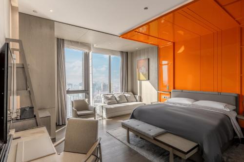 a bedroom with a large bed and a living room at Canopy by Hilton Chengdu City Centre in Chengdu