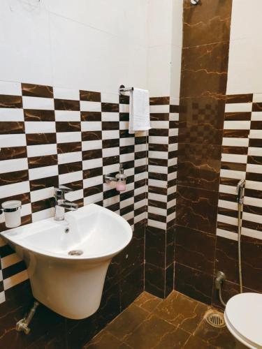 a bathroom with a sink and a toilet at Hotel The Shree Jee Palace in Mirzāpur