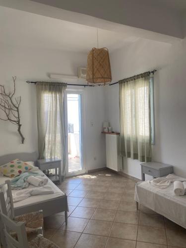 a room with two beds and a room with a window at MARGARITA STUDIOS in Antiparos