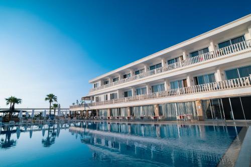 a hotel with a swimming pool in front of a building at SL La Perla Hotel Kemer in Antalya