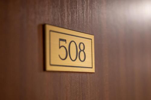 a clock on a wooden door with at Hotel Kupolen in Borlänge