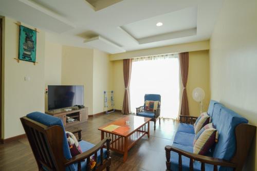 a living room with a couch and a table at Shayona Apartments Limited in Nairobi