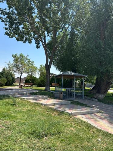a gazebo and a bench in a park at General guesthouse in Yerevan