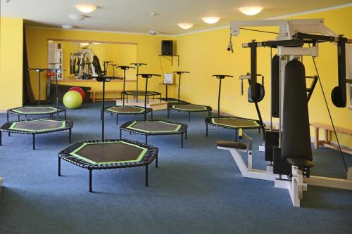 a room with a bunch of chairs in a gym at Hotel SOREA MÁJ in Liptovský Ján