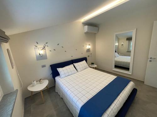 a bedroom with a large bed and a mirror at La Casina di Oscar ad AO V Combe VDA QUART 0014 e 00I6 in Quart