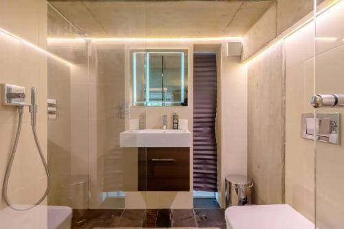 a bathroom with a sink and a toilet at Incredible 2BD Loft by Regents Canal - Haggerston in London
