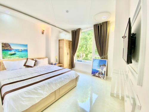 a bedroom with a bed and a large window at Diamond Hotel in Vung Tau