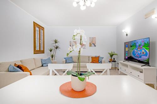 a living room with a couch and a tv at Villa Porpora Luxury Design in Modena