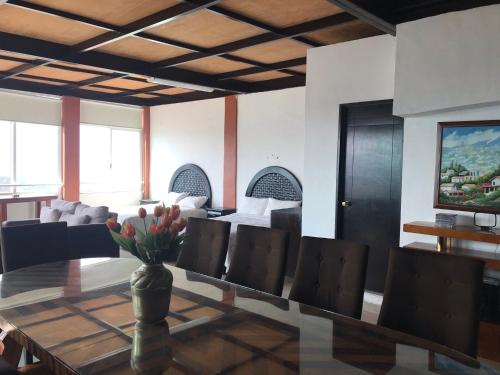 a dining room with a table and chairs at Vista Taxco in Taxco de Alarcón
