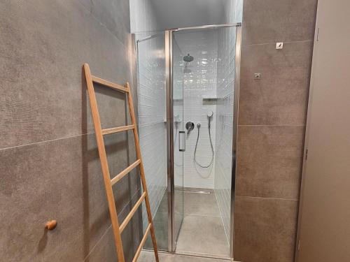 a shower with a glass door in a bathroom at Pula Residence Rooms and Apartments Old City Center in Pula