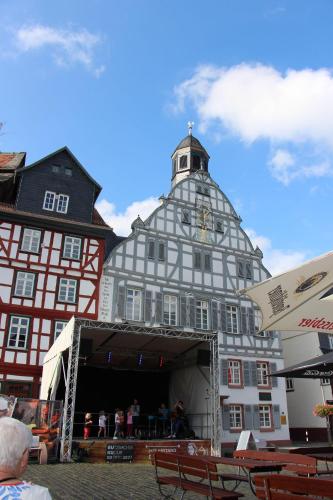 a building with a clock tower on top of it at Wohnung-Aublick in Butzbach