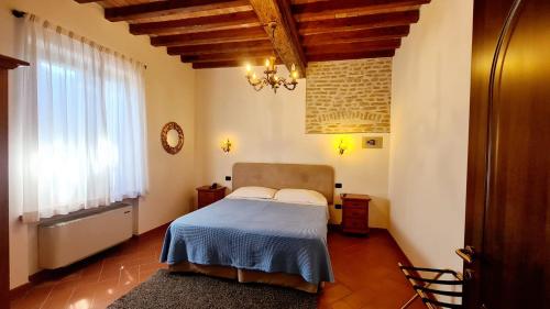 PegognagaにあるVolivia Relaisのベッドルーム1室(青い毛布、窓付)