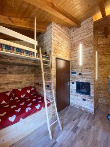 a bedroom with bunk beds in a log cabin at Home Cervino Apartments in Antey-Saint-André