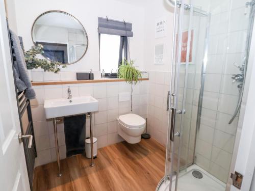 a bathroom with a toilet and a sink and a shower at The Lodge in York