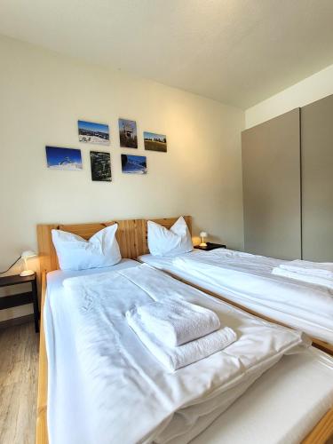 a bedroom with a large white bed with towels on it at Winterberg Appartement 21097 in Winterberg